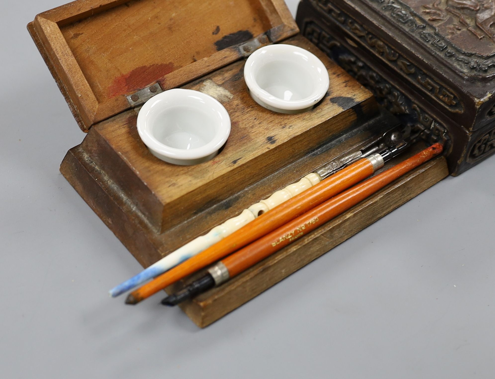 A Chinese rectangular lacquered composition box, an inkstand, three knib-pens and knibs